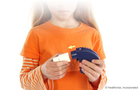 A child attaching a mouthpiece to the peak flow meter